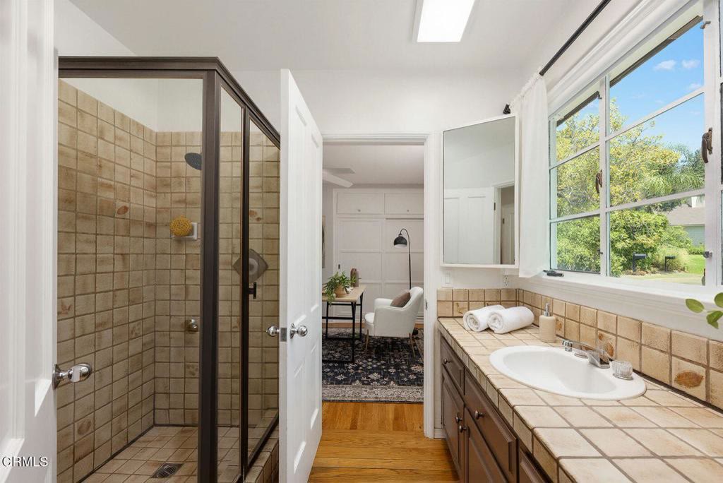 Bath with walk-in shower and tile surround