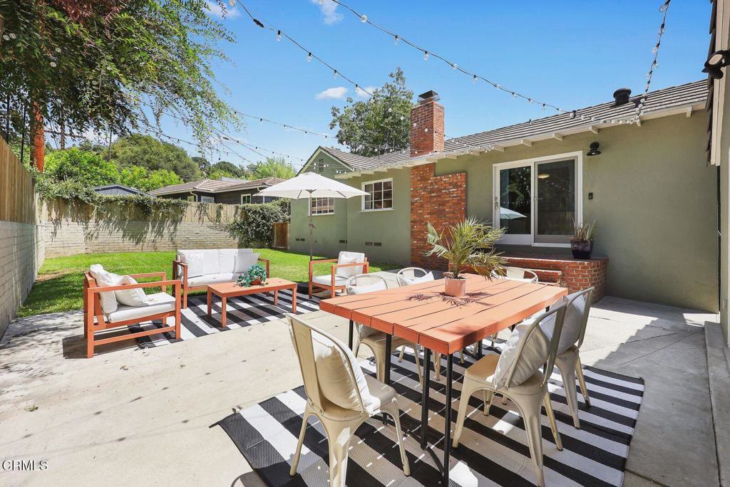 Rear patio set for al fresco dining under string lights